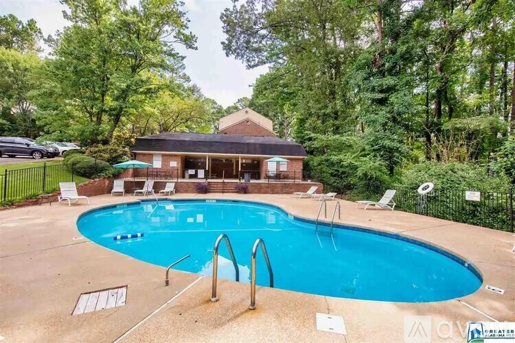 A pool with a house in the background.