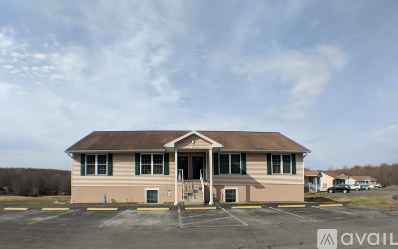 A building with a parking lot in front of it.