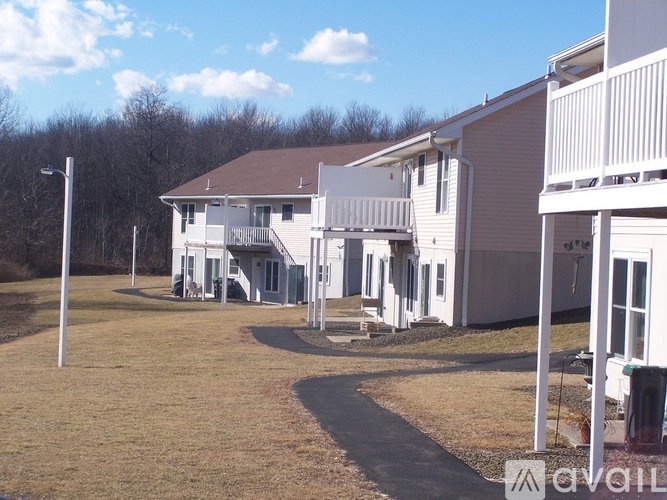 A row of houses with a grassy area in front.