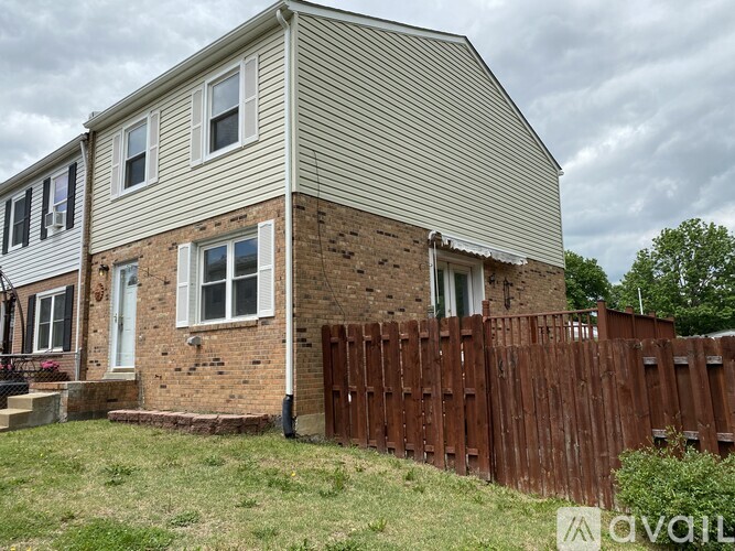 A house with a brown fence in front of it.