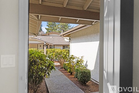 A view from the doorway of a house looking out to a landscaped yard.