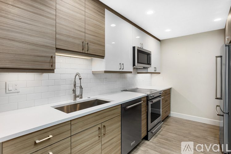 A kitchen with wooden cabinets and a white countertop.