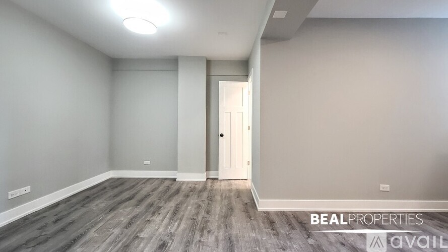 A room with a door and a wall with BEAL PROPERTIES on it.