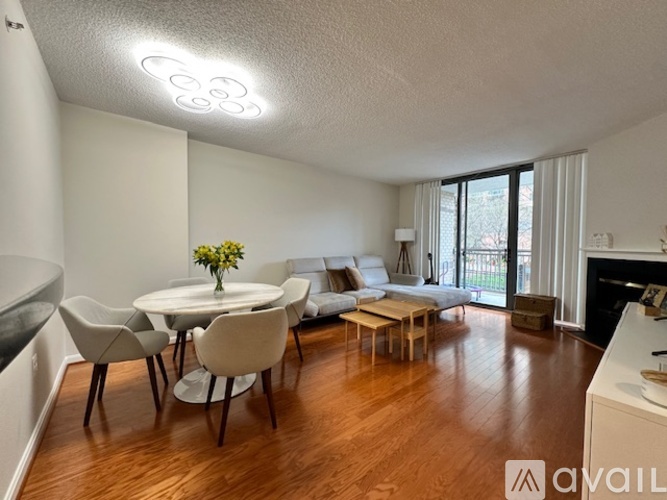A modern living room with a dining table and chairs.