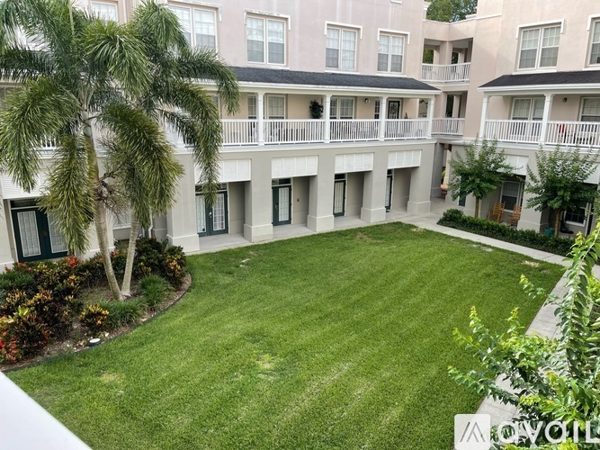 A large grassy courtyard surrounded by apartment buildings.