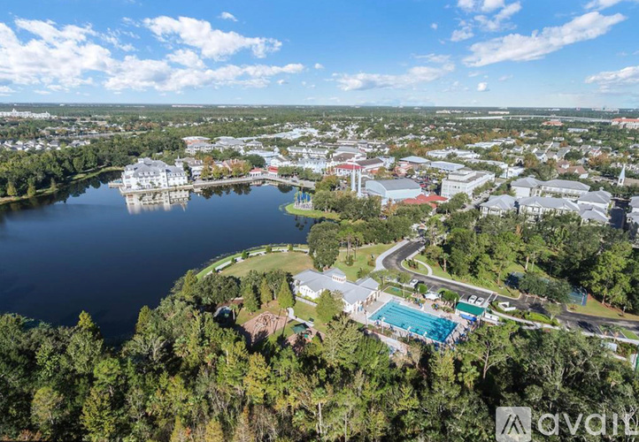 A bird's eye view of a resort with a large lake and a swimming pool.