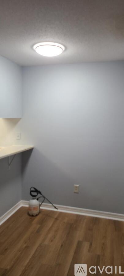 A room with a wooden floor and a white shelf.