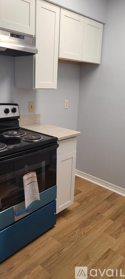 A kitchen with a stove and cabinets.