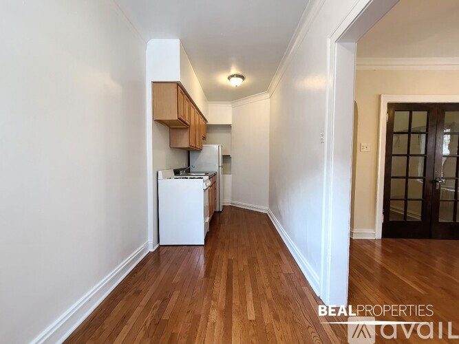 A BEALPROPERTIES advertisement for a property with a kitchen and wooden floors.