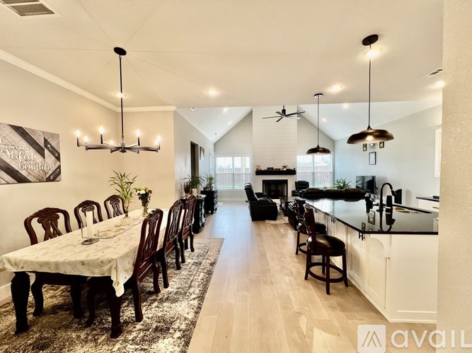 A modern kitchen with a dining table set for six.