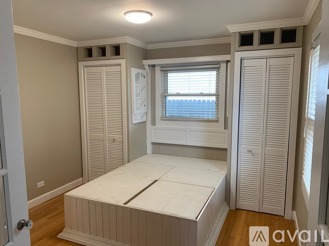 A bedroom with a bed, wardrobe, and window.