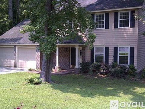 A house with a grey siding and a brown door.