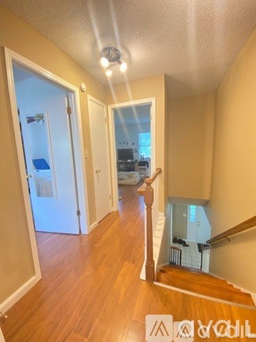 A hallway with a staircase leading to the second floor.
