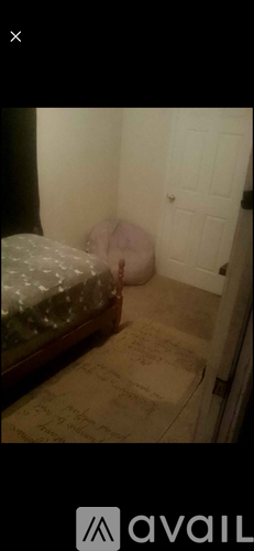 A room with a bed and a door.