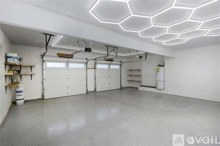 A spacious garage with a concrete floor and white walls.