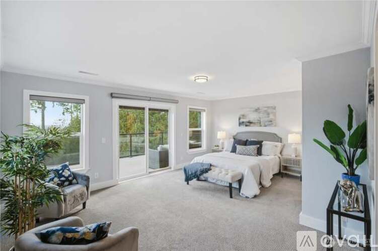 A bedroom with a large bed and a couch.