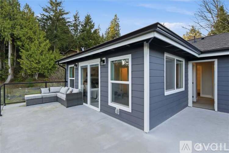 A house with a grey exterior is available for purchase.