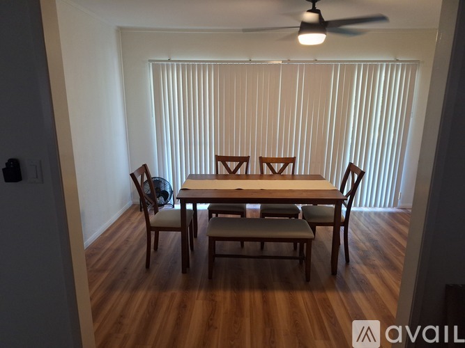 A dining room with a table and chairs.