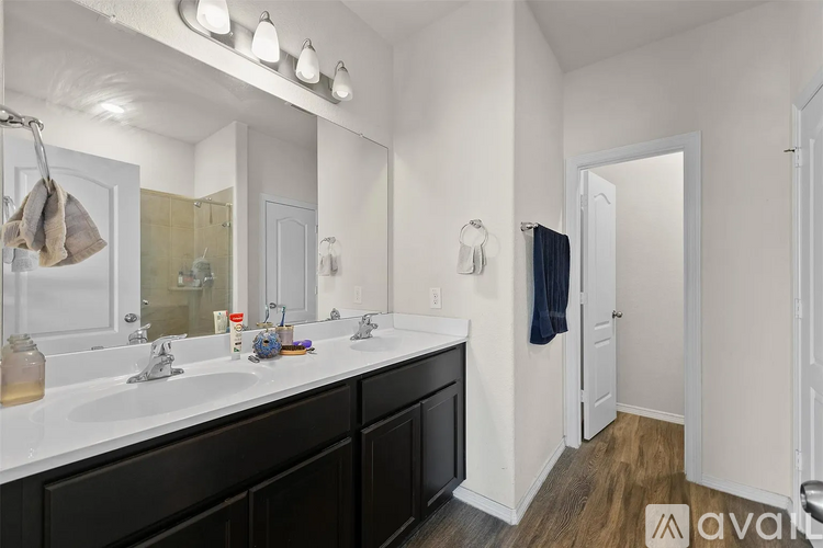A bathroom with two sinks and a large mirror.