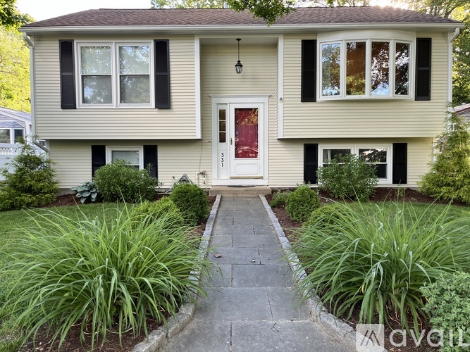 A house with a red door and a white front door with windows on either side.