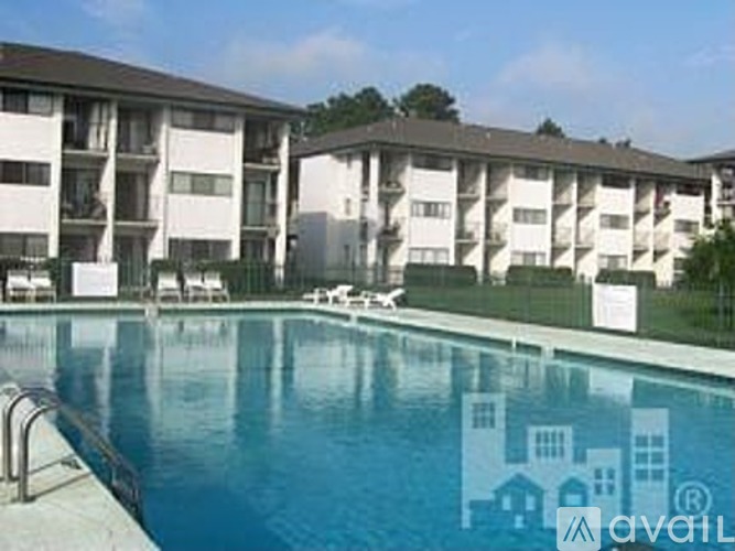A swimming pool in front of apartment buildings.
