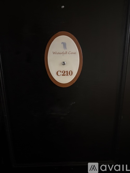 A brown circle with the words Waterford Cove C210 on it.