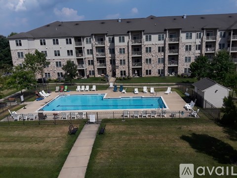 A large apartment complex with a pool in the foreground.