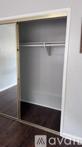 A white closet with a glass door is open.