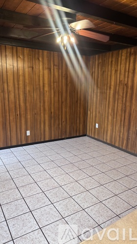 A room with wooden walls and a tiled floor.