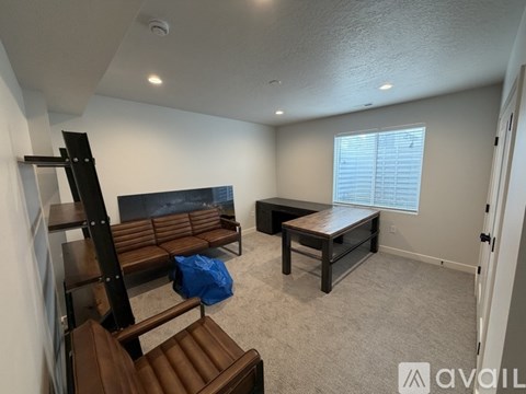 A living room with a brown couch and a wooden coffee table.