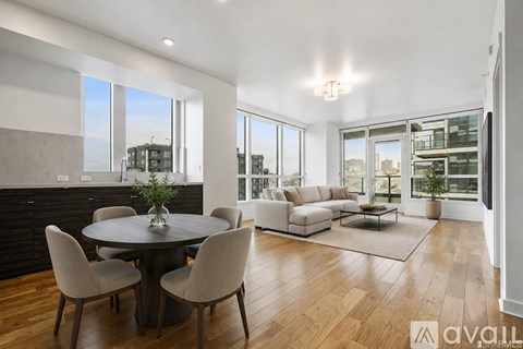 A modern living room with a round table and chairs.