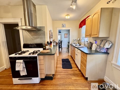 A kitchen with a stove and oven in the middle of the room.