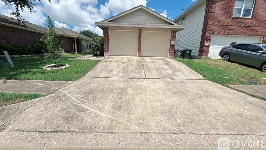 A house with a driveway in front of it.