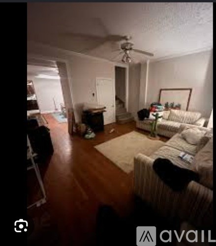 A living room with a couch and a rug.
