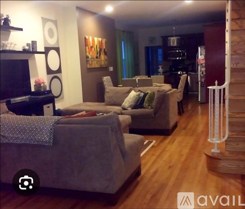 A living room with a grey couch and a television.