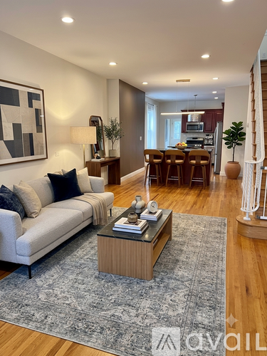 A modern living room with a white sofa and a coffee table.