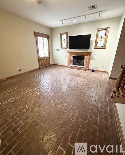 A living room with a fireplace and a television.