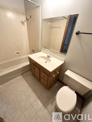 A bathroom with a toilet, sink, and bathtub.