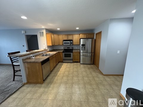 A kitchen with a refrigerator, oven, and microwave.