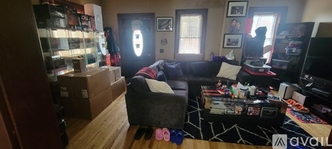 A living room with a couch, chair, and a coffee table with a rug.