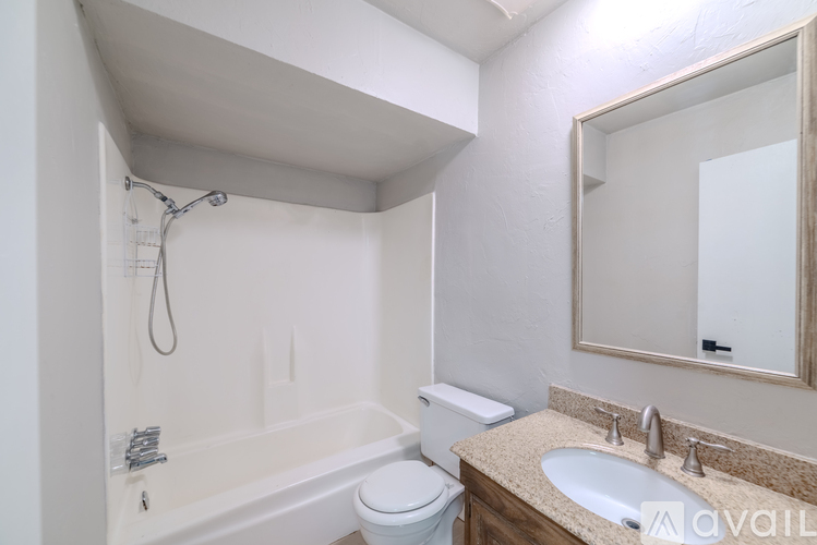 A bathroom with a toilet, sink, and bathtub.