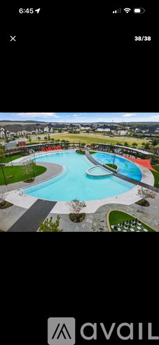 A large outdoor swimming pool surrounded by a grassy area.