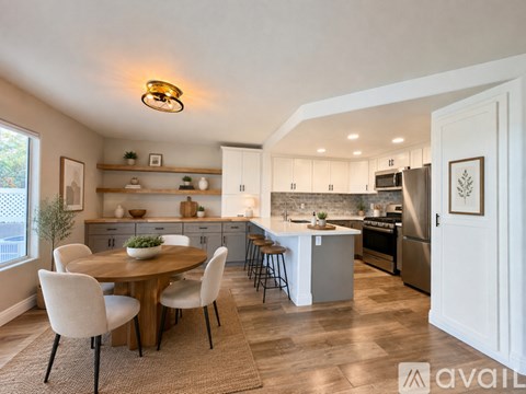 A modern kitchen with a dining table and chairs.