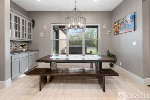 A modern dining room with a wooden table and chairs.