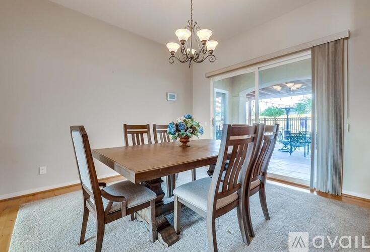 A dining room with a wooden table and chairs.