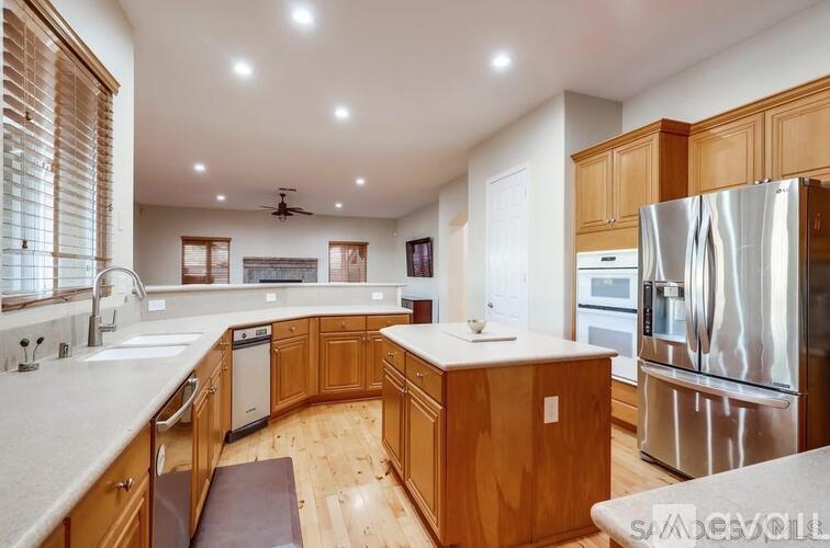 A modern kitchen with wooden cabinets and stainless steel appliances.