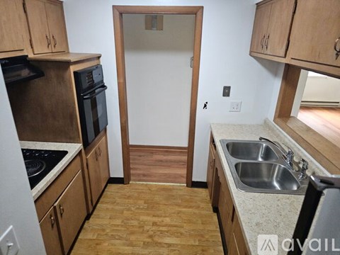 A kitchen with wooden cabinets and a white countertop.