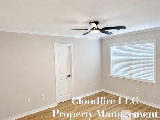A room with a ceiling fan and Cloudfire LLC Property Management written on the wall.