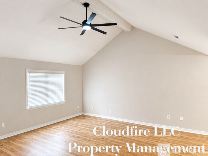 A room with a ceiling fan and Cloudfire LLC Property Management written on the wall.