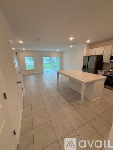A kitchen with a white countertop and black appliances.